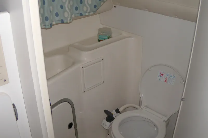 Slide: The Image of Bathroom interior of 1994 Bayliner 2859 Classic Cruiser with toilet and storage. - 16