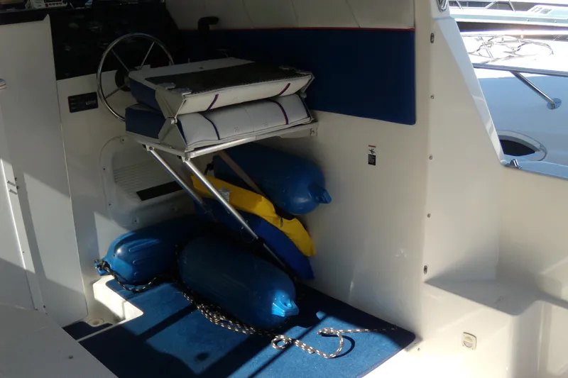 Slide: The Image of 1994 Bayliner 2859 Classic Cruiser interior with steering wheel, seat, and blue fenders. - 18