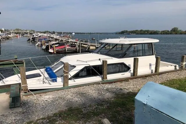 Slide: The Image of 1994 Bayliner 2859 Classic Cruiser docked by a scenic waterfront. - 20