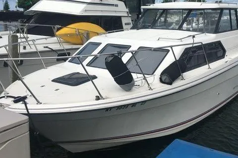 Slide: The Image of 1994 Bayliner 2859 Classic Cruiser docked at marina with other boats. - 21