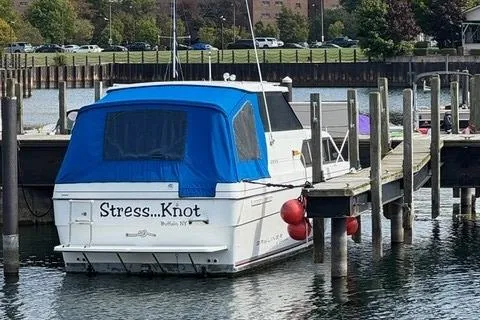 Slide: The Image of 1994 Bayliner 2859 Classic Cruiser named "Stress...Knot" docked with blue canopy. - 22