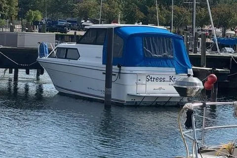 Slide: The Image of 1994 Bayliner 2859 Classic Cruiser docked with blue canopy in marina. - 23