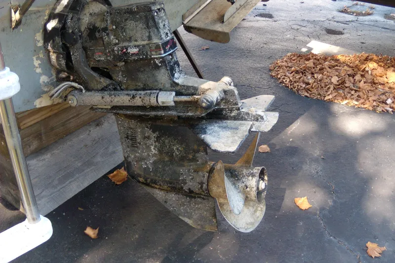 Slide: The Image of 1994 Bayliner 2859 Classic Cruiser outboard motor with visible wear and propeller. - 5