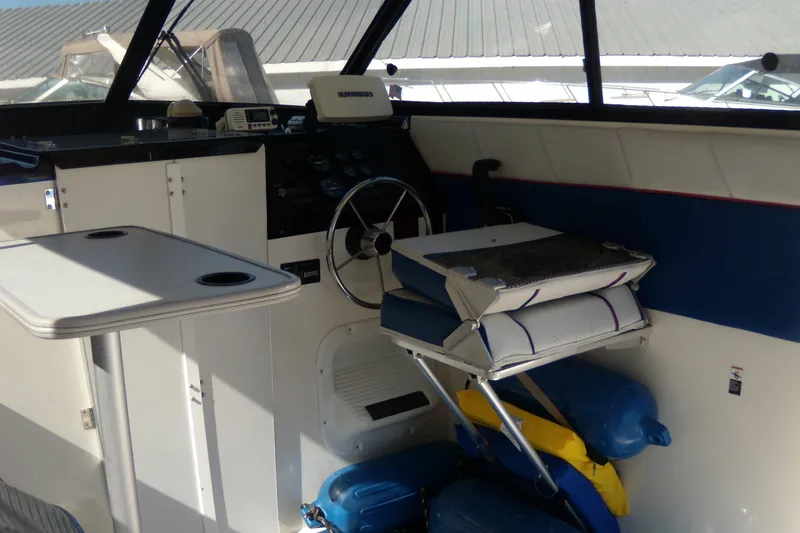 Slide: The Image of 1994 Bayliner 2859 Classic Cruiser helm with steering wheel and seating area. - 7