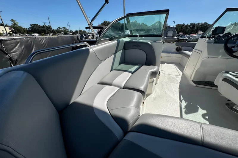 Slide: The Image of 2021 NauticStar 203 DC boat interior with gray seating and steering console. - 21