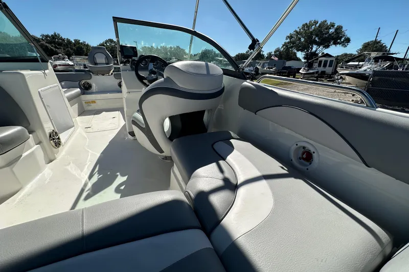 Slide: The Image of 2021 NauticStar 203 DC boat interior with gray seating and steering wheel. - 22