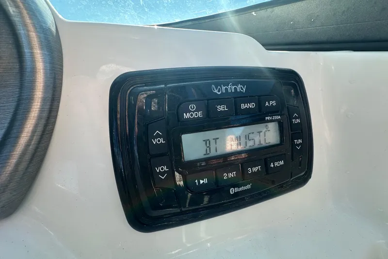Slide: The Image of Infinity stereo system on 2021 NauticStar 203 DC boat, displaying "BT MUSIC". - 33