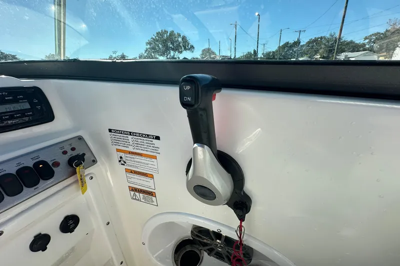 Slide: The Image of 2021 NauticStar 203 DC boat control panel with throttle and checklist. - 35