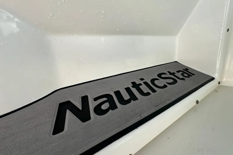 Slide: The Image of NauticStar 203 DC boat logo on a sleek, modern surface, 2021 model. - 37