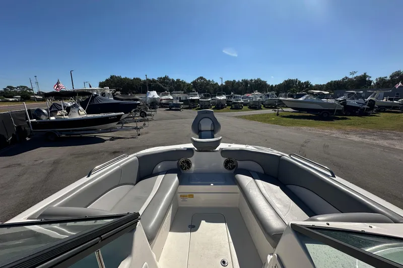 Slide: The Image of 2021 NauticStar 203 DC boat interior with seating, parked among other boats. - 39