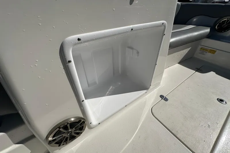 Slide: The Image of 2021 NauticStar 203 DC boat interior with storage compartment and speaker. - 41