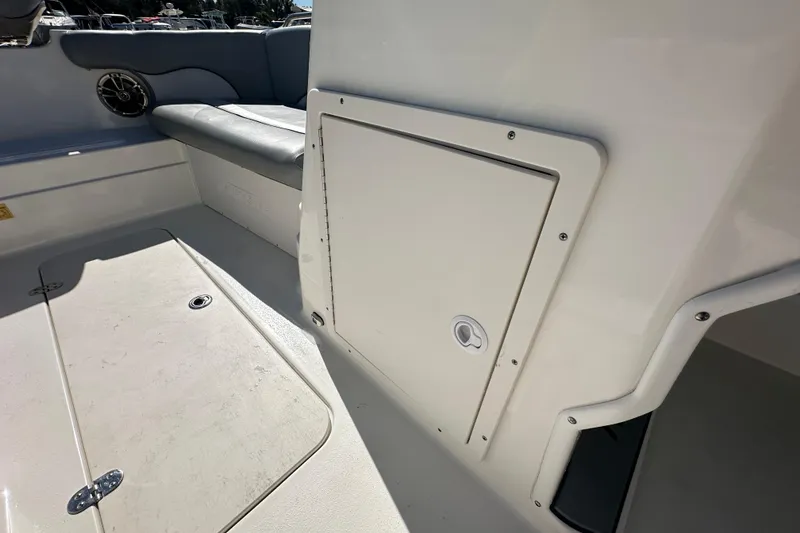 Slide: The Image of 2021 NauticStar 203 DC boat interior with storage compartment and seating area. - 42