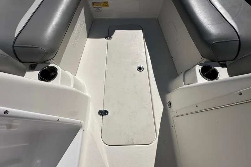 Slide: The Image of 2021 NauticStar 203 DC boat interior with gray seating and cup holders. - 45