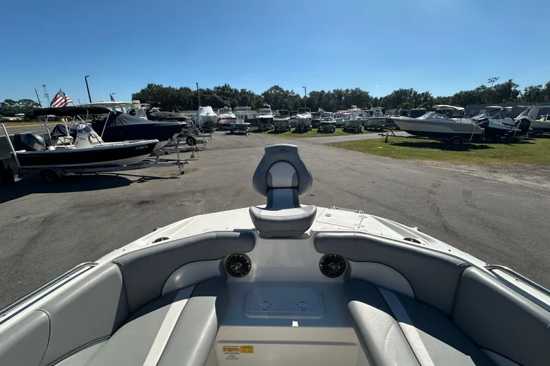 Slide: The Image of 2021 NauticStar 203 DC boat in a marina, surrounded by various other boats. - 47