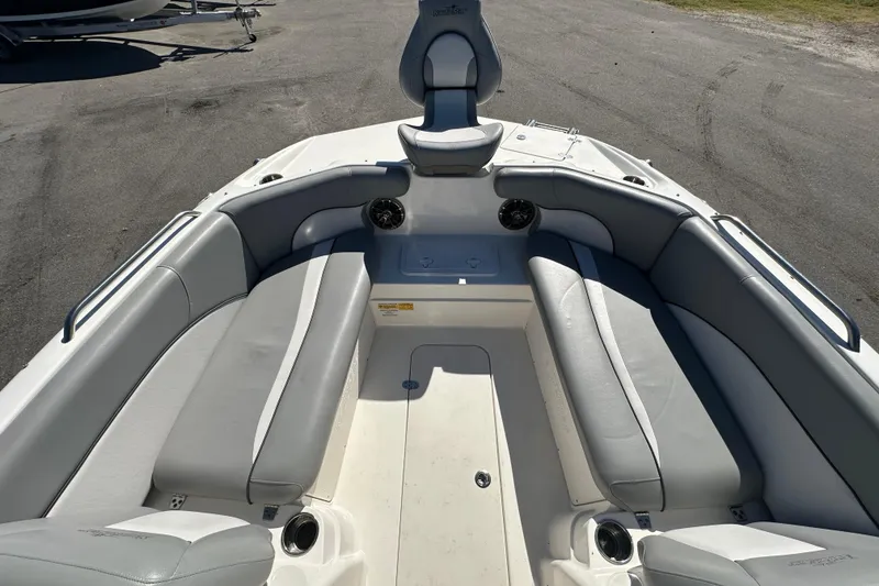 Slide: The Image of 2021 NauticStar 203 DC boat interior with gray seating and cup holders. - 48