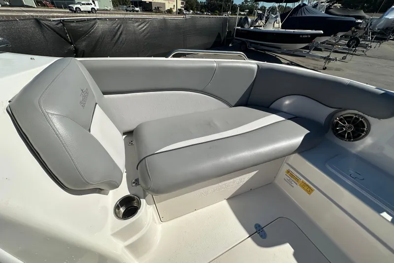 Slide: The Image of 2021 NauticStar 203 DC boat interior with gray seating and cup holder. - 49