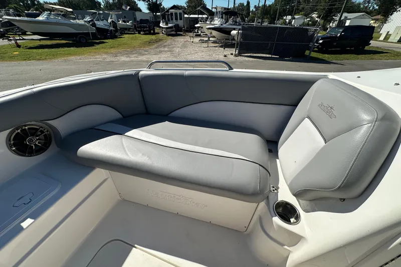 Slide: The Image of 2021 NauticStar 203 DC boat interior with gray seating and speaker. - 50