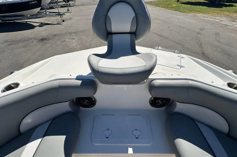 Slide: The Image of 2021 NauticStar 203 DC boat interior with gray seating and cup holders. - 52