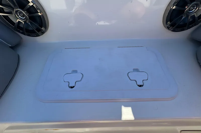 Slide: The Image of 2021 NauticStar 203 DC boat interior with speakers and storage compartment. - 53