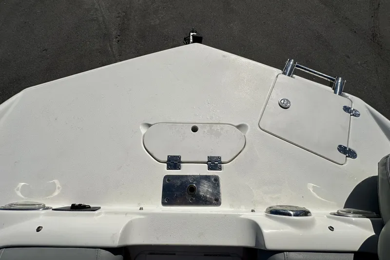 Slide: The Image of 2021 NauticStar 203 DC boat deck with storage compartments and cup holders. - 56