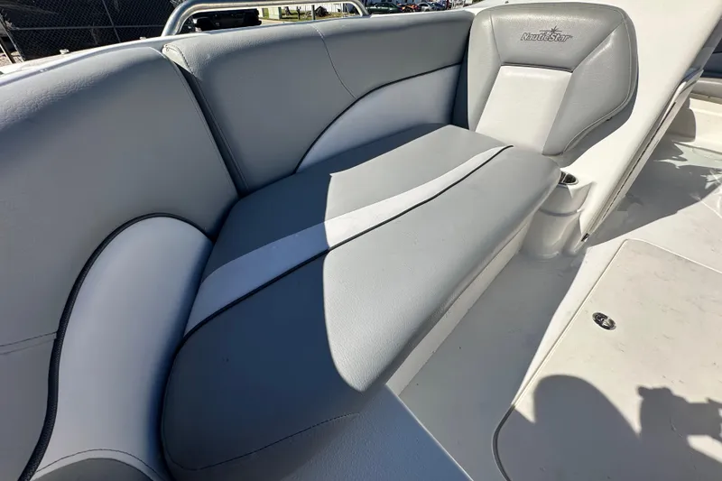 Slide: The Image of 2021 NauticStar 203 DC boat interior with gray cushioned seating. - 64