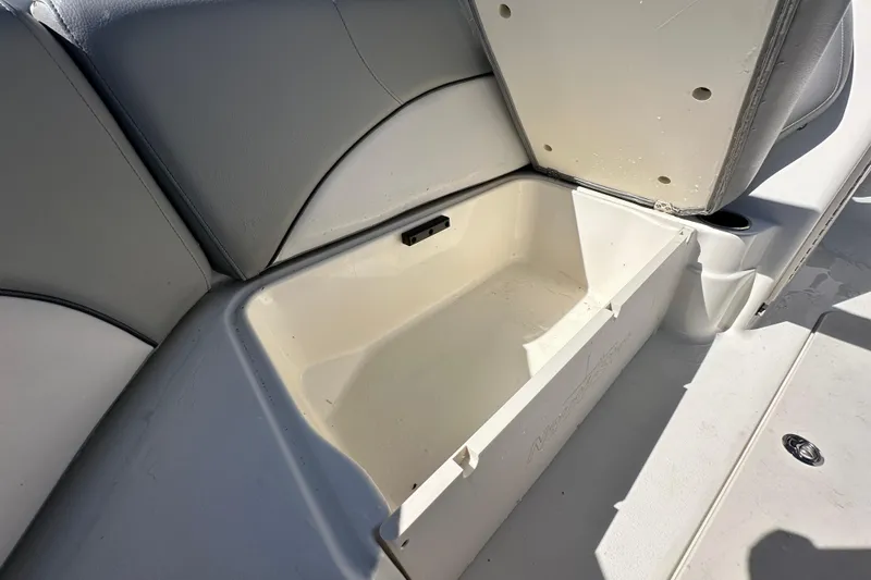 Slide: The Image of Open storage compartment on 2021 NauticStar 203 DC boat seat. - 65
