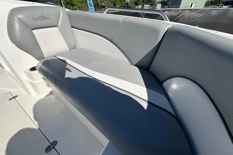 Slide: The Image of 2021 NauticStar 203 DC boat interior with gray and white seating. - 66