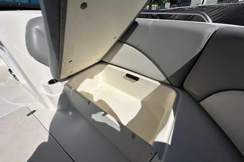 Slide: The Image of 2021 NauticStar 203 DC boat seat storage compartment open, showcasing interior space. - 67