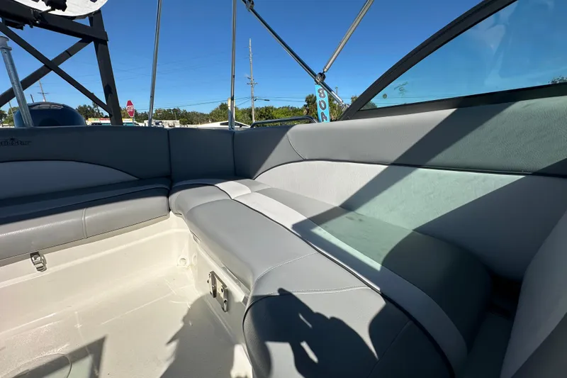 Slide: The Image of 2021 NauticStar 203 DC boat interior with gray seating and clear blue sky. - 74