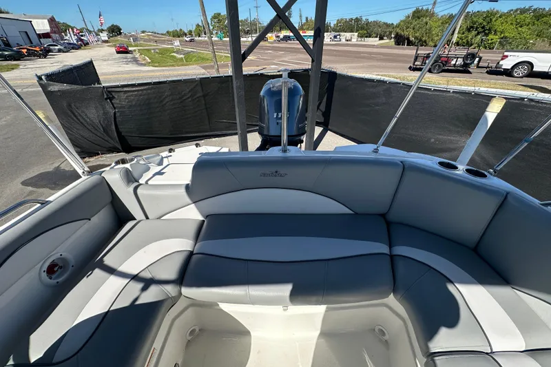 Slide: The Image of 2021 NauticStar 203 DC boat interior with gray seating and cup holders. - 76