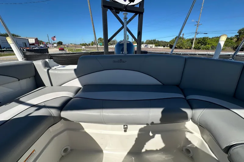 Slide: The Image of 2021 NauticStar 203 DC boat interior with gray seating and open deck view. - 77