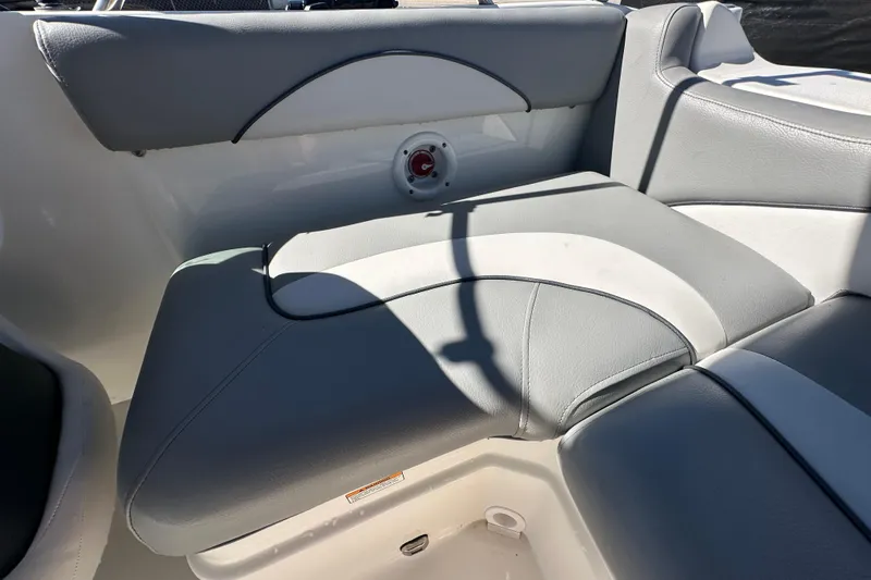 Slide: The Image of 2021 NauticStar 203 DC boat interior with gray and white cushioned seating. - 78