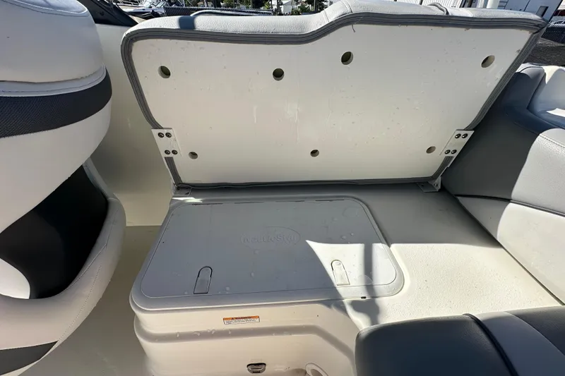 Slide: The Image of 2021 NauticStar 203 DC boat interior storage compartment with open seat lid. - 80