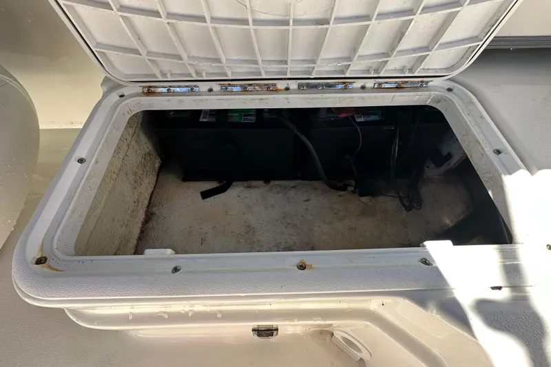 Slide: The Image of Open storage compartment on 2021 NauticStar 203 DC boat, showing interior space. - 81
