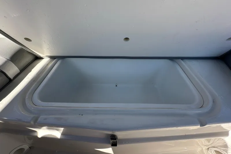 Slide: The Image of 2021 NauticStar 203 DC boat storage compartment, open and empty. - 83