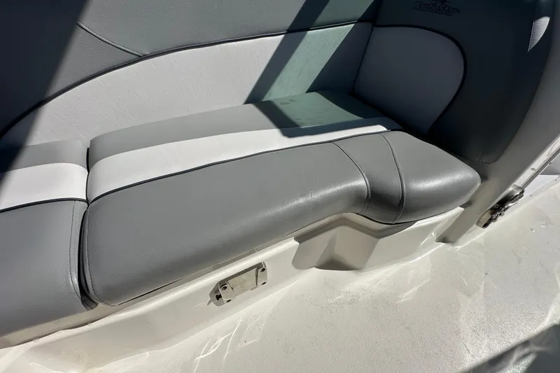 Slide: The Image of 2021 NauticStar 203 DC boat interior with gray and white cushioned seating. - 85