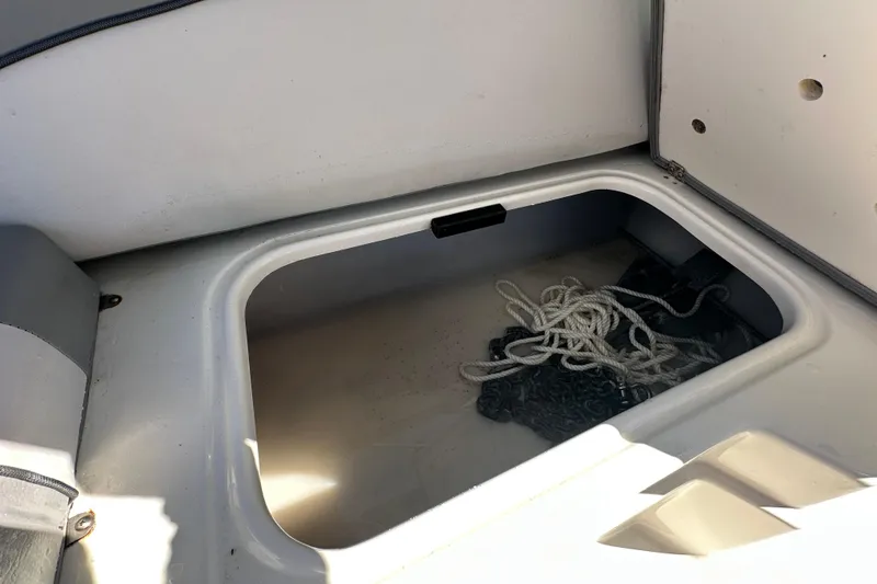 Slide: The Image of Storage compartment with rope in 2021 NauticStar 203 DC boat. - 86