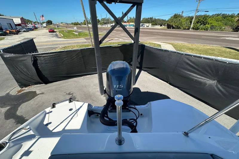 Slide: The Image of 2021 NauticStar 203 DC boat with Yamaha 115 engine, parked outdoors. - 88
