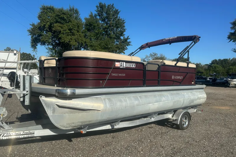 Slide: The Image of 2020 Godfrey SWEETWATER 2186 SB pontoon boat on trailer, parked outdoors. - 0