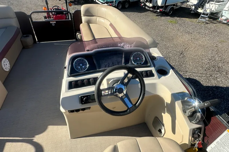 Slide: The Image of 2020 Godfrey SWEETWATER 2186 SB boat interior with steering wheel and dashboard controls. - 11