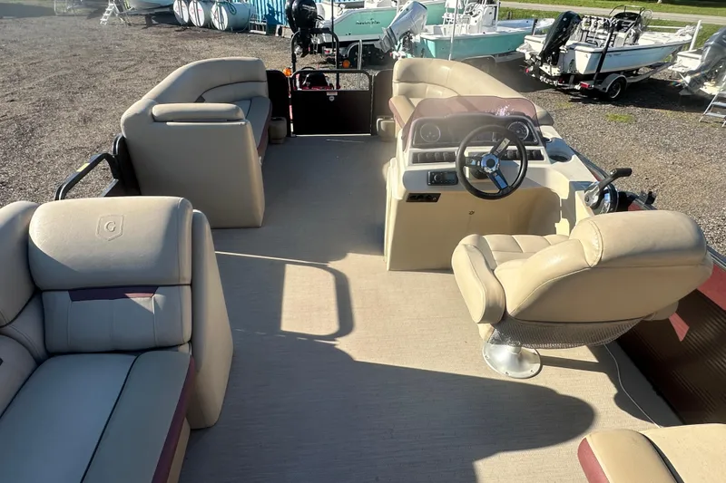 Slide: The Image of Interior of 2020 Godfrey SWEETWATER 2186 SB pontoon boat with beige seating and steering console. - 14