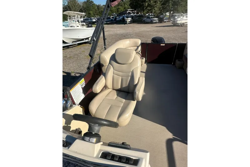 Slide: The Image of 2020 Godfrey SWEETWATER 2186 SB boat interior with beige captain's chair and steering wheel. - 16