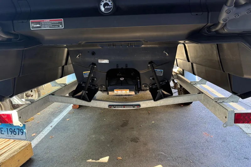 Slide: The Image of 2024 Sea-Doo Switch Cruise 21 on trailer, rear view showing hull and suspension. - 2