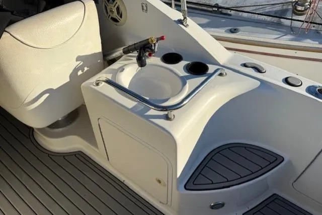 Slide: The Image of 1999 Sea Ray 260 Sundancer boat interior with sink and seating area. - 16