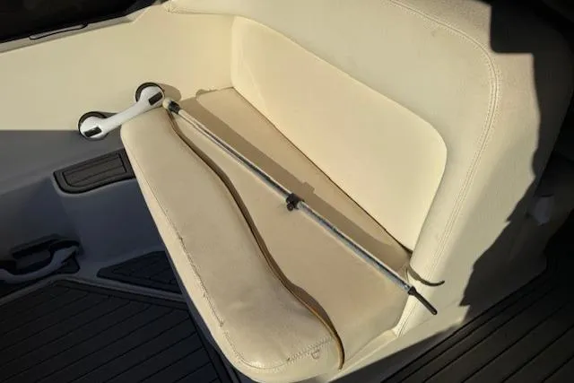 Slide: The Image of 1999 Sea Ray 260 Sundancer interior with beige seating and a metal rod. - 17