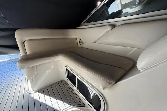 Slide: The Image of 1999 Sea Ray 260 Sundancer interior seating with cushioned bench and sleek design. - 20