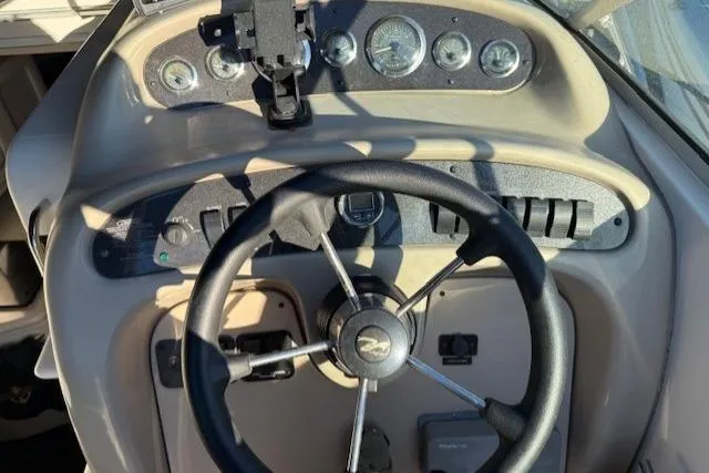 Slide: The Image of 1999 Sea Ray 260 Sundancer dashboard with steering wheel and instrument panel. - 21