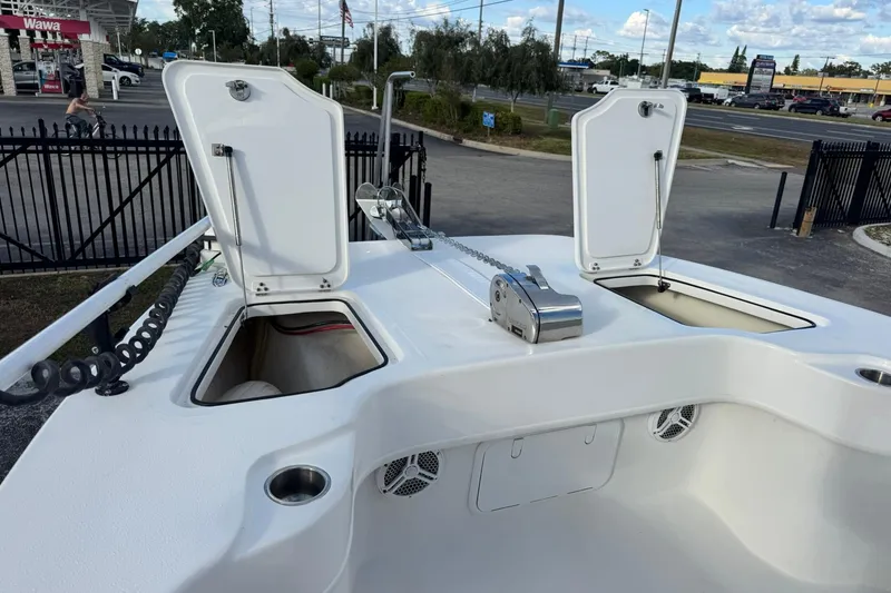 Slide: The Image of 2021 Twin Vee 260 CC GF boat with open storage compartments and anchor chain. - 14