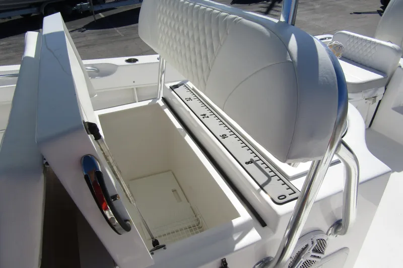 Slide: The Image of 2021 Twin Vee 260 CC GF boat with open storage compartment and cushioned seating. - 20