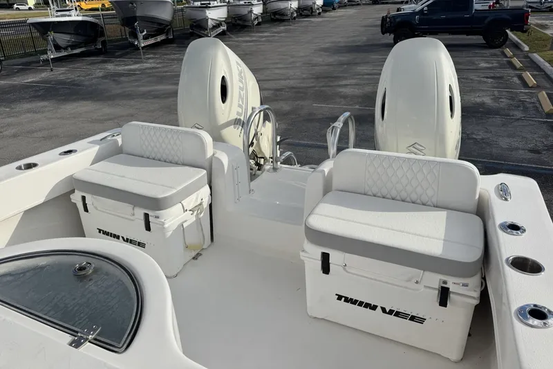 Slide: The Image of 2021 Twin Vee 260 CC GF boat interior with seating and Suzuki engines. - 26